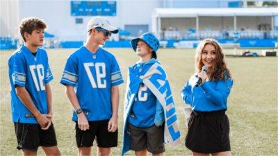 Cristiana Rosa interviewing three Lions fans during Training Camp